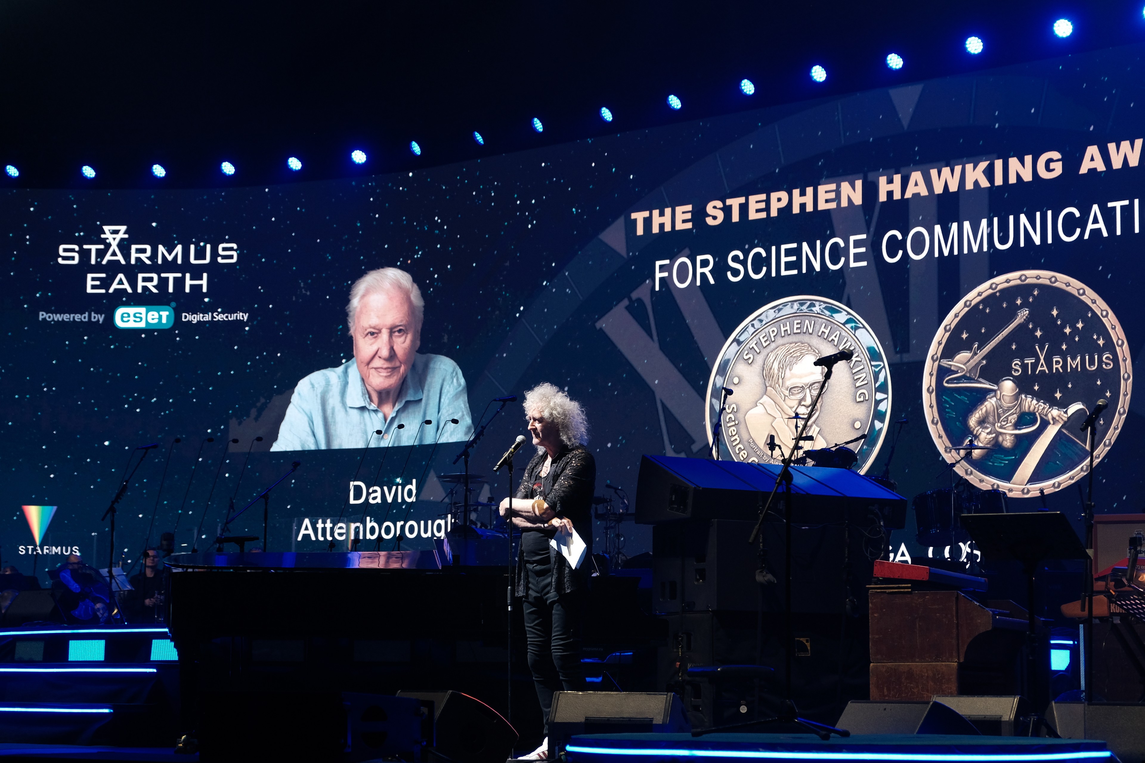 a person in a suit receives an award onstage