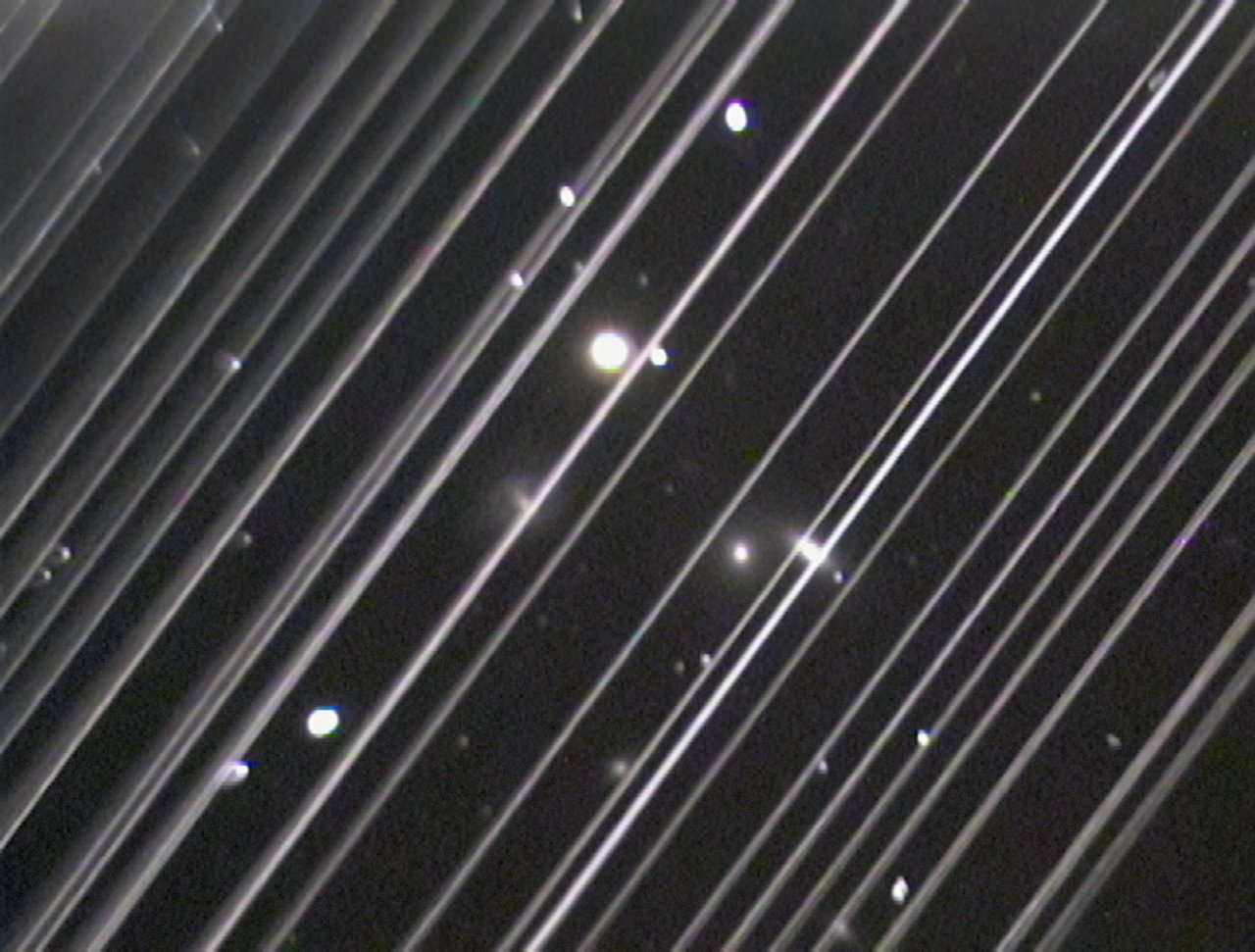 streaks of white light in front of stars