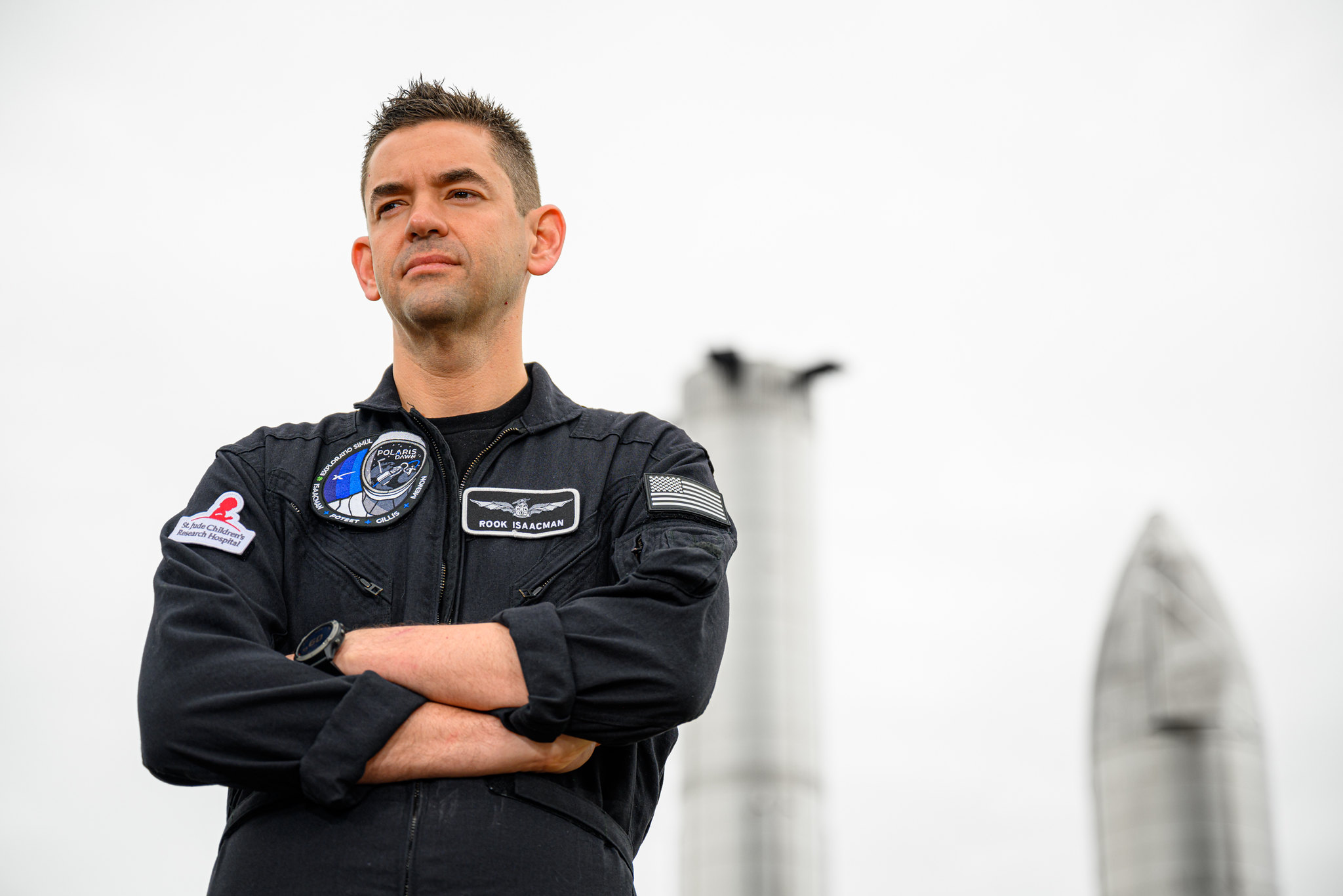 jared isaacman standing in front of starship prototypes