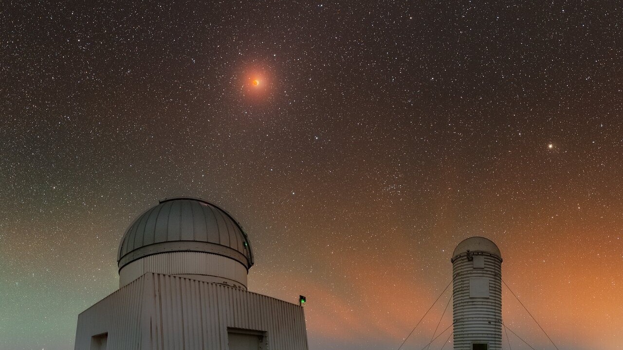 A lunar eclipse steals the show in a colorful sky | Space photo of the day for July 18, 2025