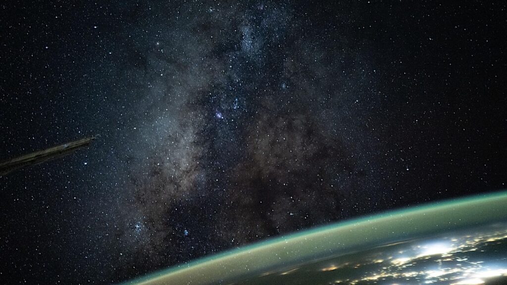The Milky Way Looms Above The Atmospheric Glow Of a Habitable Planet